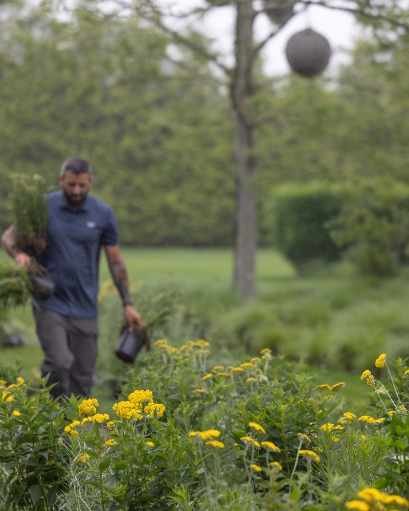 Owen Brothers Landscaping team member tending flowers.
